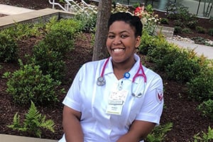 NCCU | Eagle Promise Realized: NCCU Student Smiling in Nursing Uniform