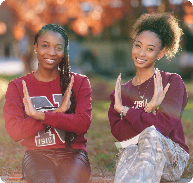 Two female NCCU students sit on campus